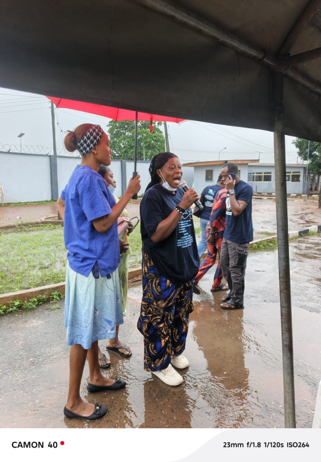 A volunteer delivering health education to the community in the rain, Agbowa-Ikosi 2026