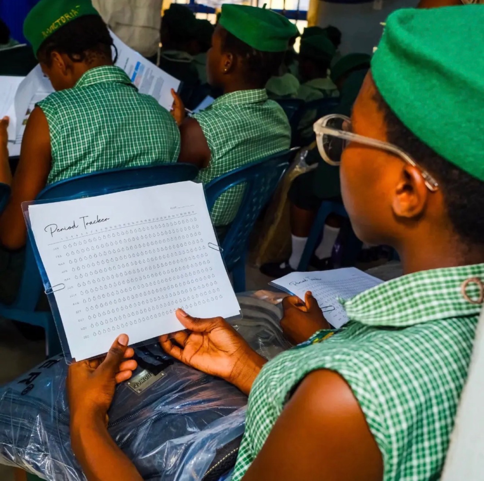 Students reading their health and hygiene booklets at the Sagamu outreach, 2026